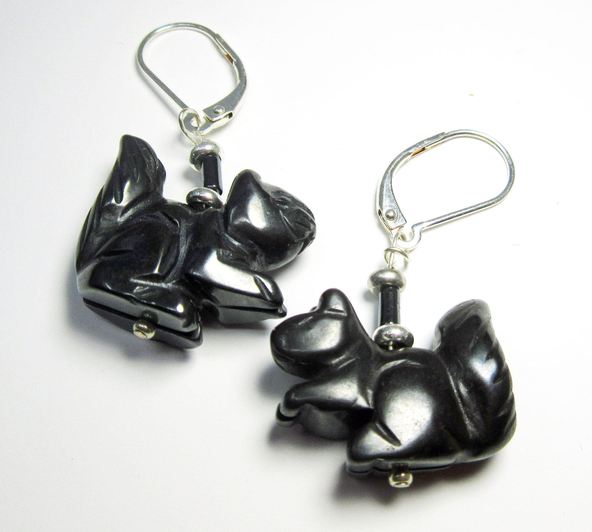 Squirrel Earrings: Carved stone squirrel charms with black beads hang from sterling silver lever backs, shown on a white background.