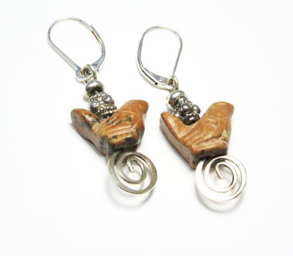Close-up of Songbird Earrings, showcasing intricate carved stone designs ideal for spring and summer accessories.