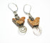 The Carved Jasper Songbird Earrings feature brown bird-shaped beads with silver accents and coiled wire dangles—an ideal handcrafted gift for bird lovers&