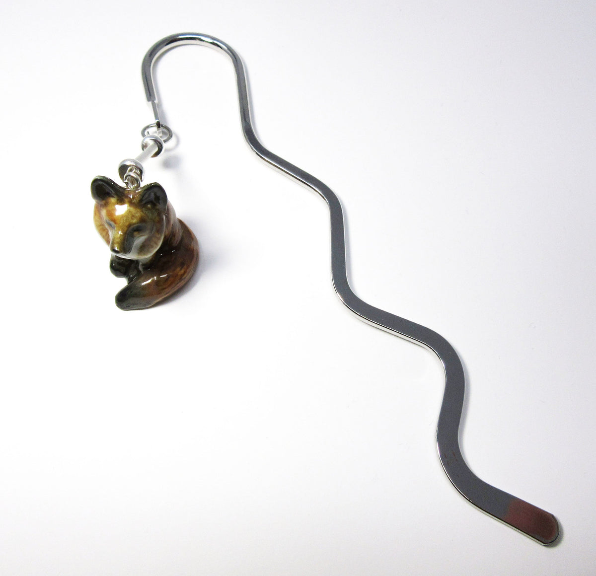 Durable silver squiggle bookmark featuring a beautifully painted porcelain fox, great for keeping your page in books