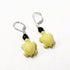 Handcrafted Color Changing Sea Turtle Earrings featuring yellow turtle charms with dark beads and silver hooks—an ideal ocean lover gift. Displayed on a white background.