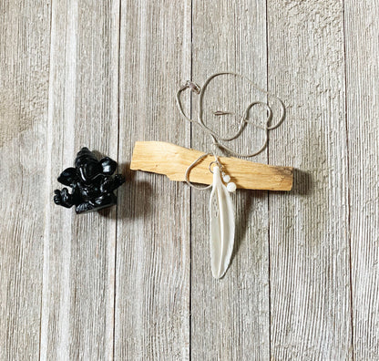 White Feather Necklace from Enlivenadorn by Gwynstone, representing hope and protection, hanging on a delicate snake chain.