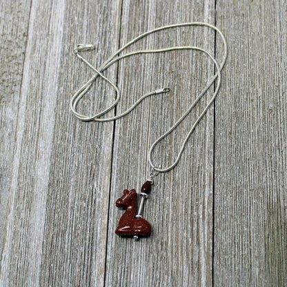 Giraffe Necklace on display with an 18-inch chain, a beautiful accessory for animal lovers and those who embrace positivity.