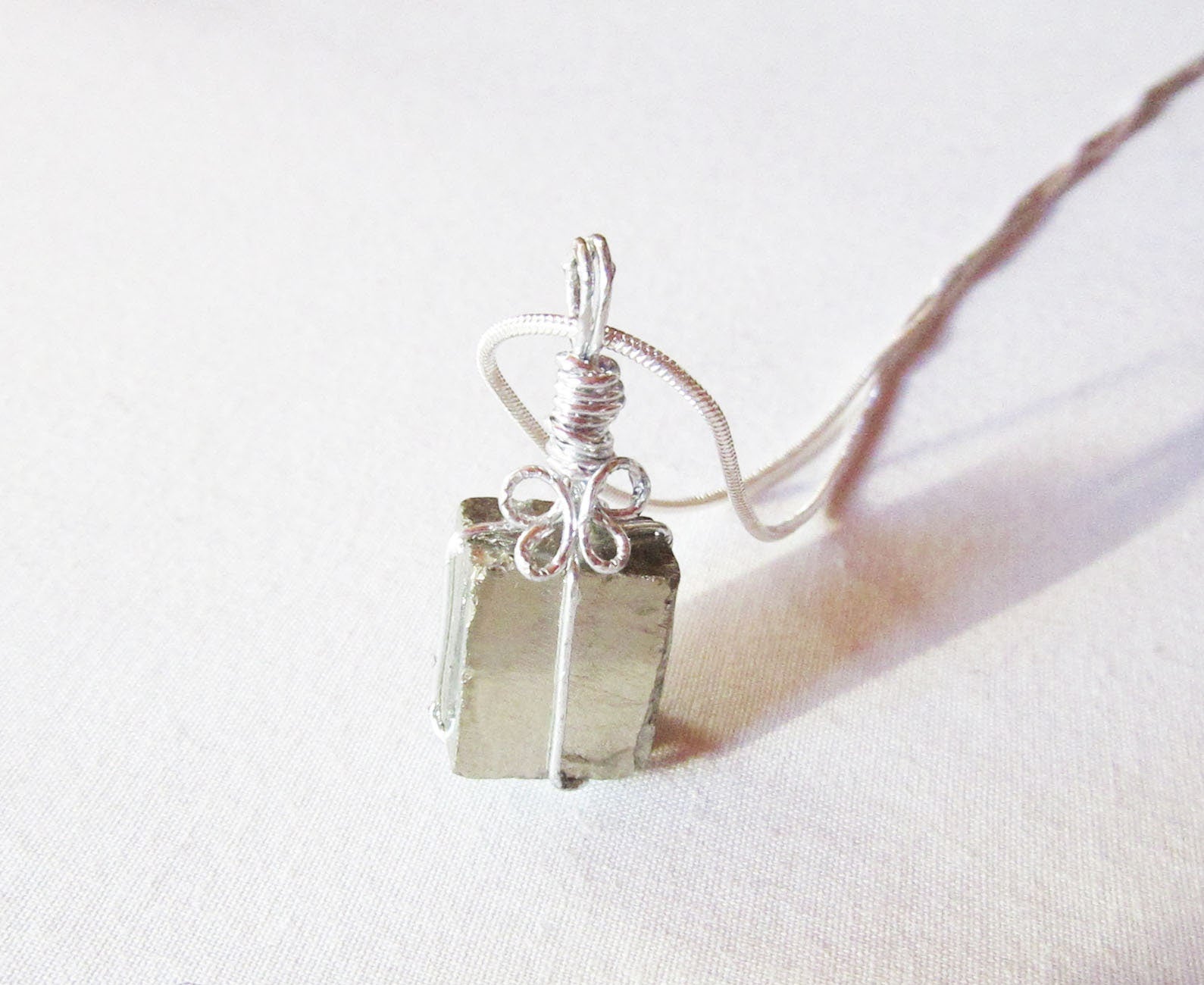 Close-up view of the Pyrite Crystal Pendant, featuring the glimmering gold tones of the wire wrapped choker, ideal for protective stone jewelry.