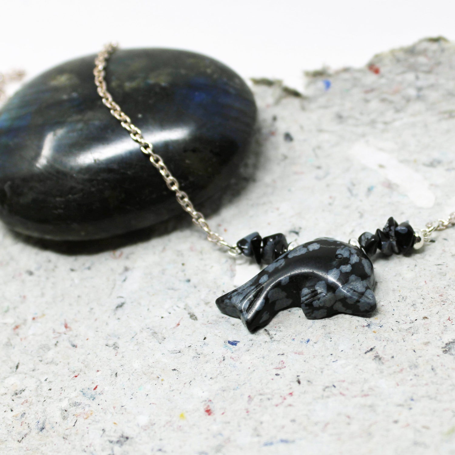 Close-up of Snowflake obsidian dolphin choker - Sea Life Necklace Gift showcasing intricate carving and ocean-inspired design, perfect gift for dolphin lovers.