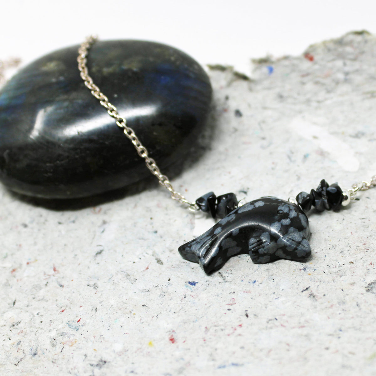Close-up of Snowflake obsidian dolphin choker - Sea Life Necklace Gift showcasing intricate carving and ocean-inspired design, perfect gift for dolphin lovers.