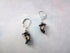 Hand Painted Orca Whale Earrings - Sterling Silver Lever Backs featuring small, hand painted black and white orca charms against a light, textured background.