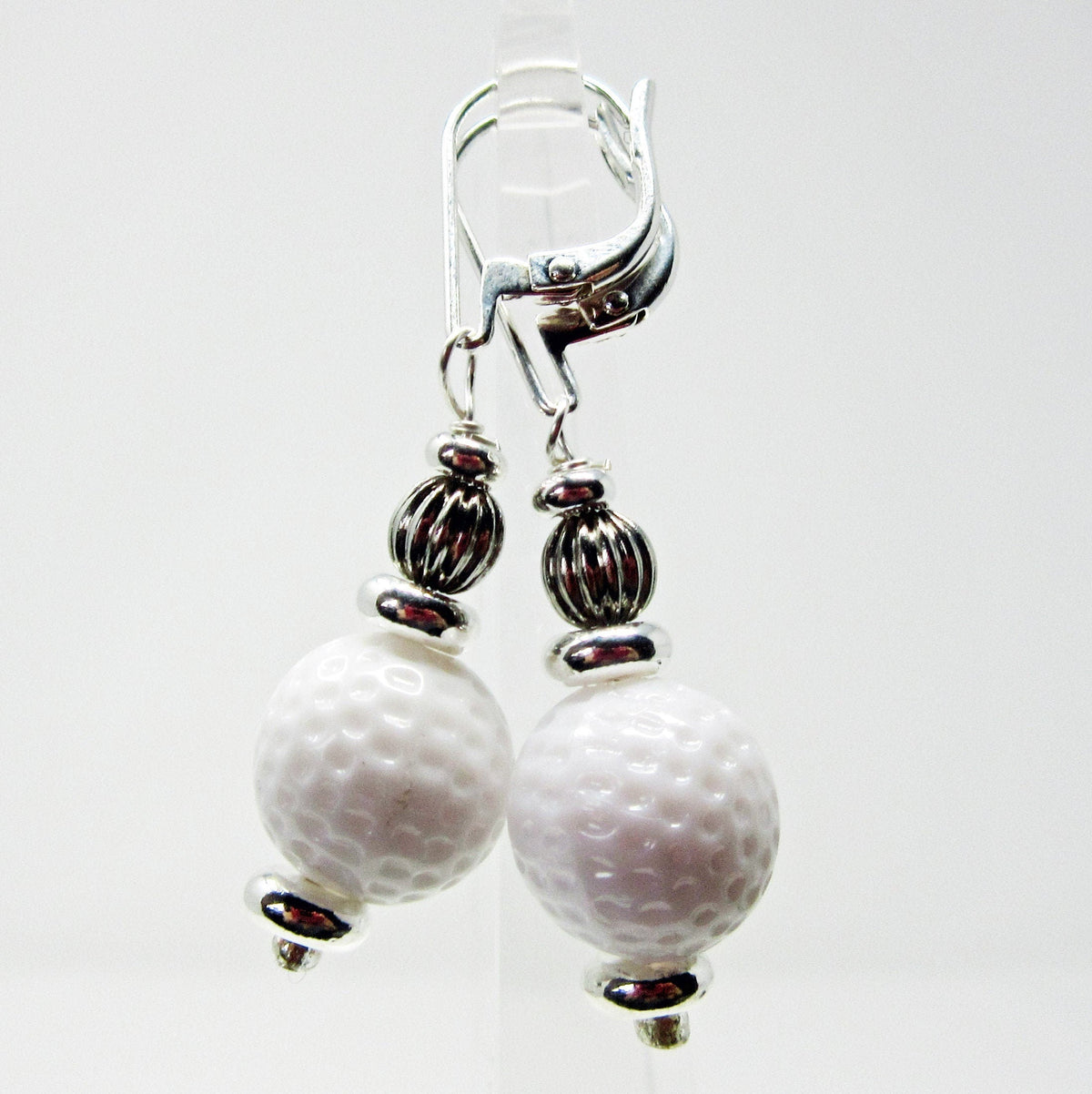 Golf Ball Lever Back Earrings: Golfer Jewelry not to tee you off—white golf ball-textured beads with silver-toned spacers and ribbed accents on lever back hooks, ideal for any golf lover.