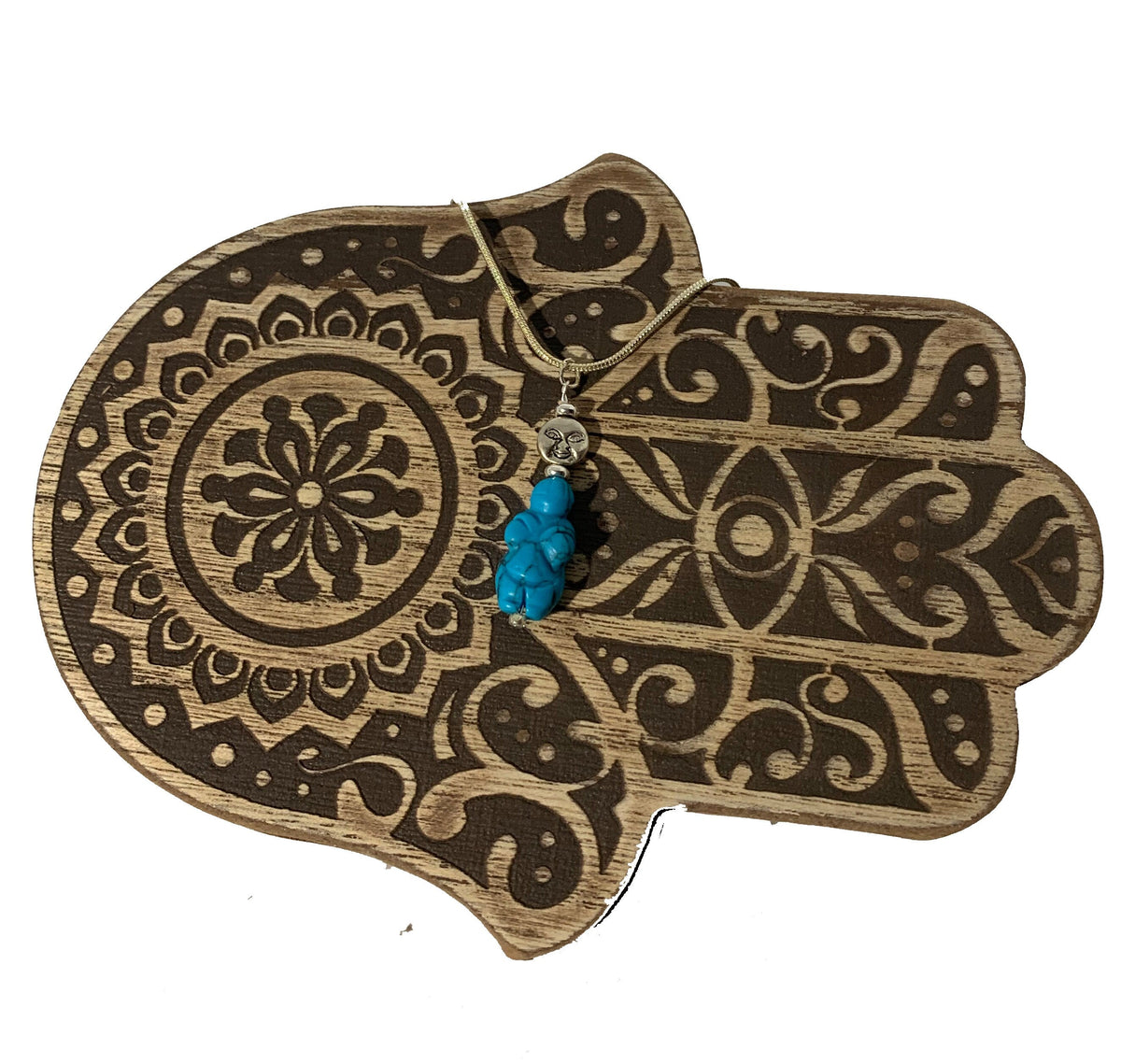 Close-up of Goddess of Willendorf - Moon Priestess Turquoise Pendant highlighting its intricate details and symbolism of woman power and fertility.