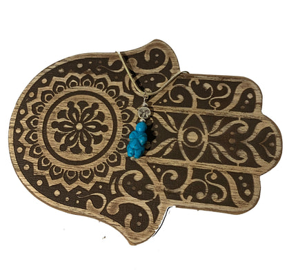 Close-up of Goddess of Willendorf - Moon Priestess Turquoise Pendant highlighting its intricate details and symbolism of woman power and fertility.