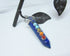 The Chakra Stones Pendant features seven colorful gemstones in a vertical design on a silver chain. This healing gemstone jewelry is ideal for yoga lovers and adds vibrant energy to your style.