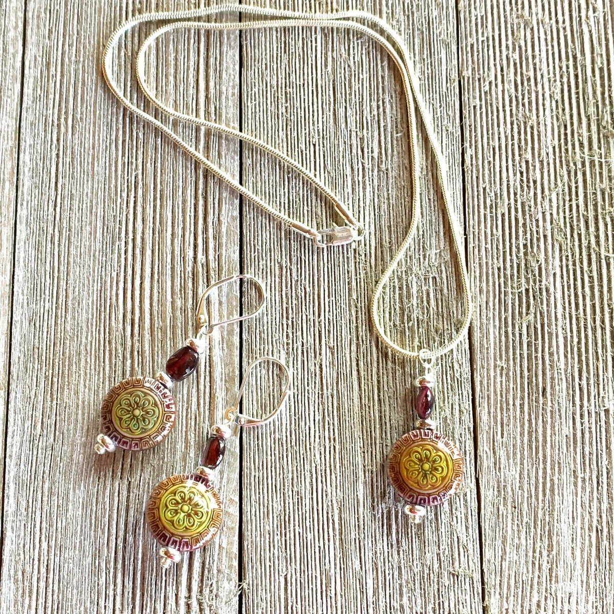 Close-up of the elegant Magic Mandala and Garnet earrings, showcasing the intricate design and mood-changing bead, ideal for healing and meditation.
