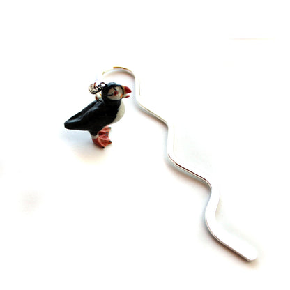 Puffin Bird metal bookmark placed in a cozy reading nook, perfect as a gift for avid readers, ocean lovers, and ornithologists.