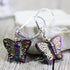 Shimmery Butterfly Earrings: AB Crystal Aurora Borealis Finish, with metallic purple, green, and gold butterfly accents on sterling silver lever-back hooks, displayed against a soft neutral background.