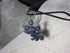Whimsical Handcrafted Sodalite Bear Earrings feature small blue gemstone bear charms and round blue beads, hanging from sterling silver lever backs, shown on a black cord against a light background.