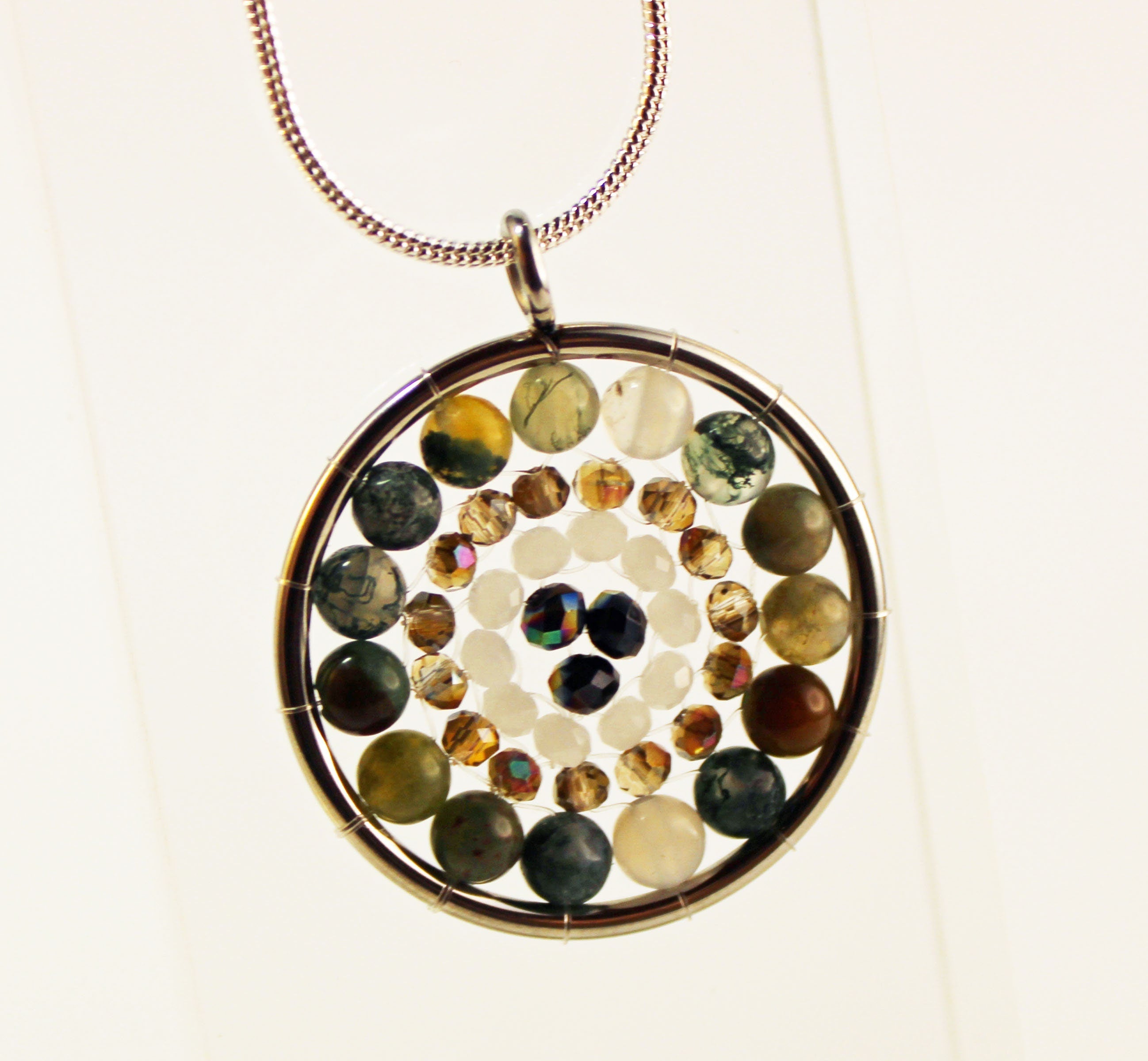 Artisan-crafted Mandala Pendant necklace with a silver medalion and zen aesthetics, combining beauty and tranquility.