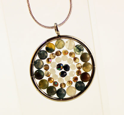 Artisan-crafted Mandala Pendant necklace with a silver medalion and zen aesthetics, combining beauty and tranquility.