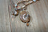 Ammonite fossil partner jewelry necklace set featuring an inch and a half pendant with opalescent bands.