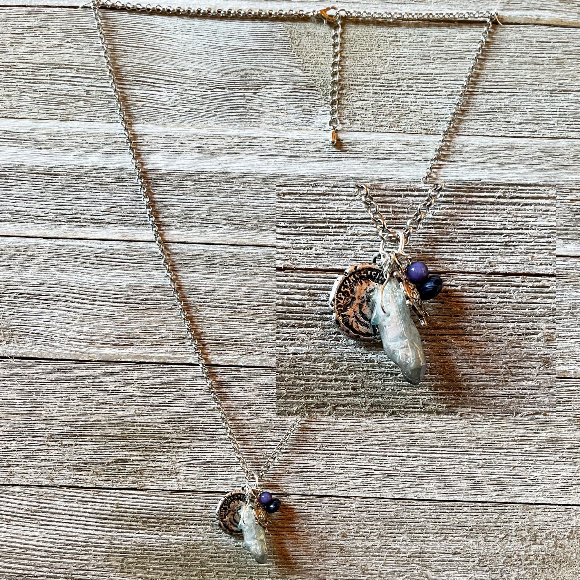Close-up of the Pirate’s Booty Charm Necklace showcasing its shimmering silver design and unique nautical treasures.