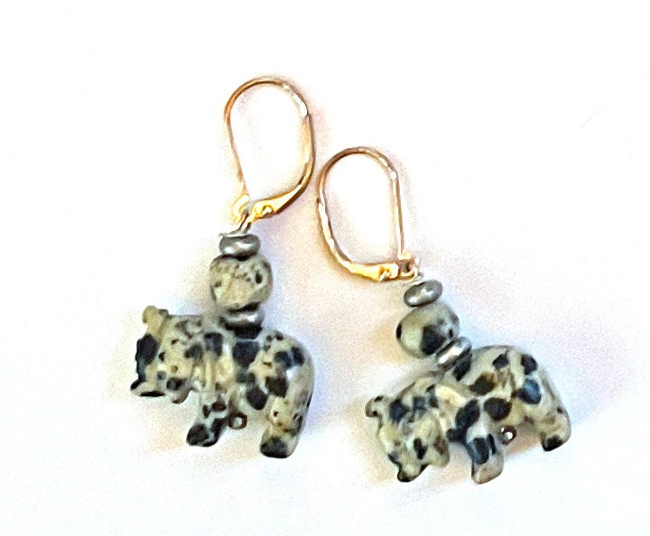 Close-up of Elephant Earrings showcasing intricate carvings of elephants, made from various natural stones including quartz, offering a unique accessory for animal lovers.