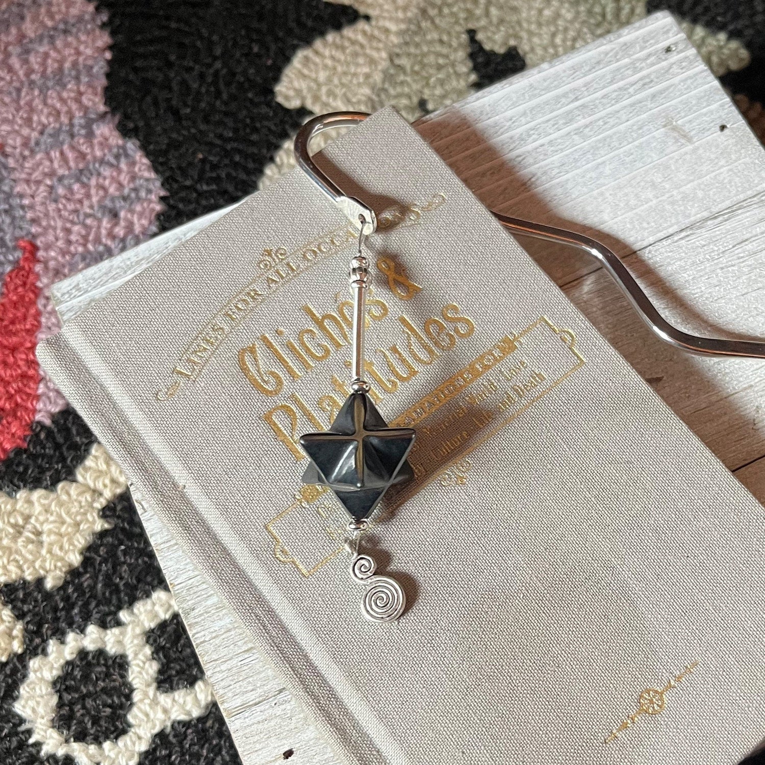 Detailed view of Sacred Geometry Merkaba Bookmark with Hematite showcasing intricately carved silver spine, perfect for meditation and spiritual reflection.