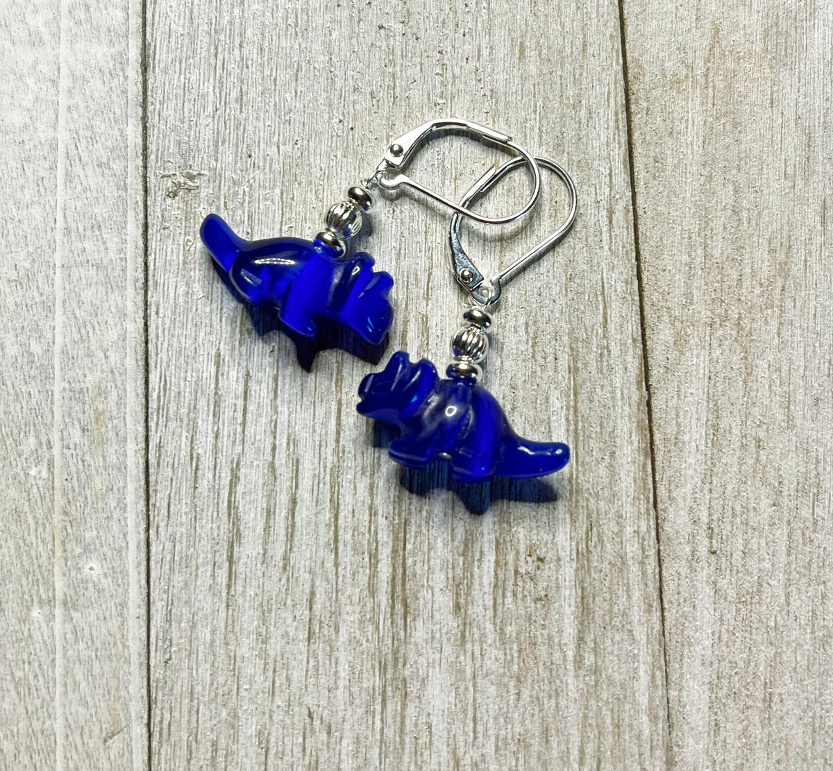 Triceratops earrings - playful dinosaur earrings featuring blue carved stone, perfect as a fun gift for dinosaur lovers.