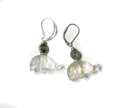 Close-up of Clear Quartz Drop Earrings shaped like manatees, showcasing detailed carvings ideal for ocean-themed gifts.