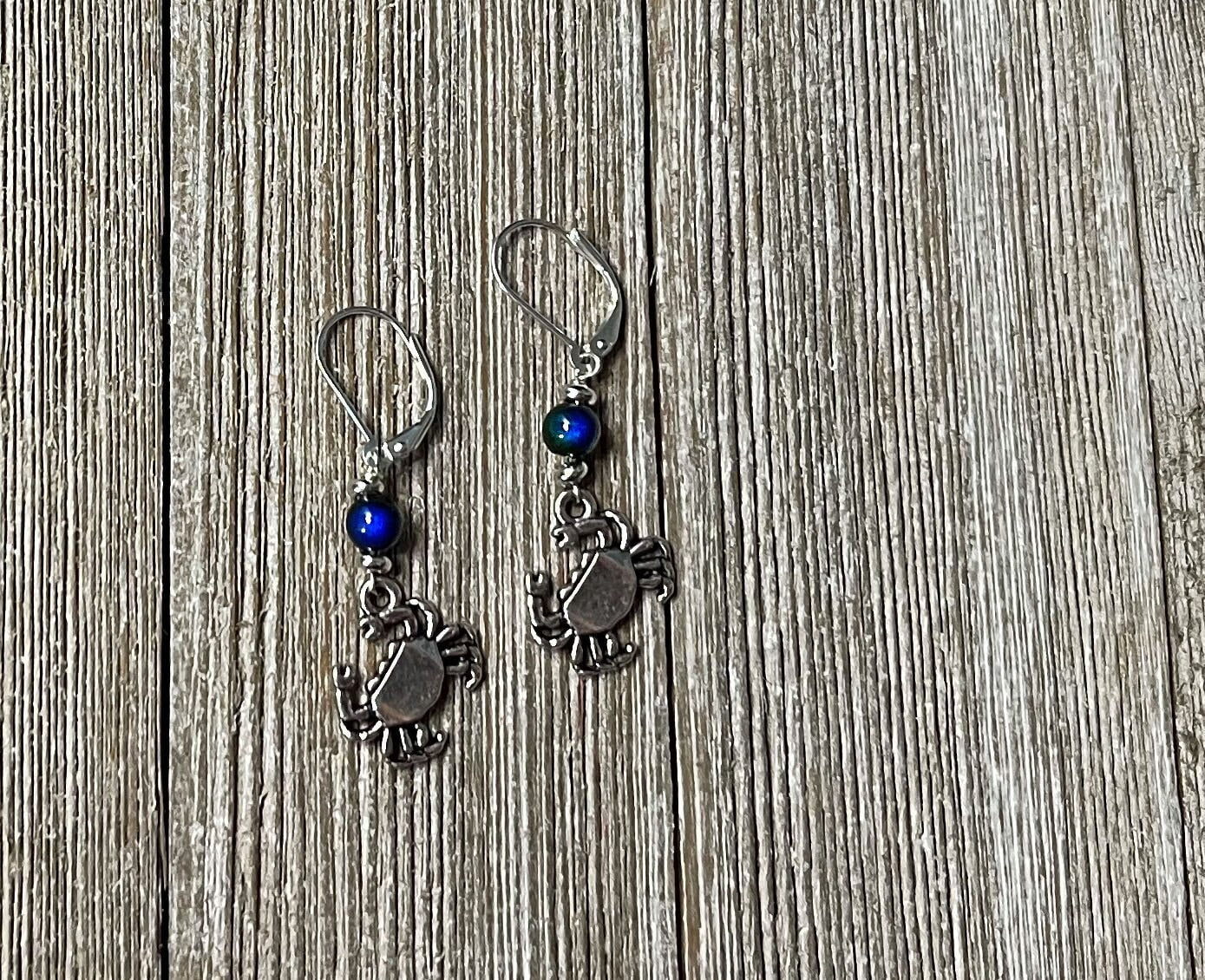 Detail of Color Changing Crab Dangle Earrings, featuring unique craftsmanship and ocean-themed elements.