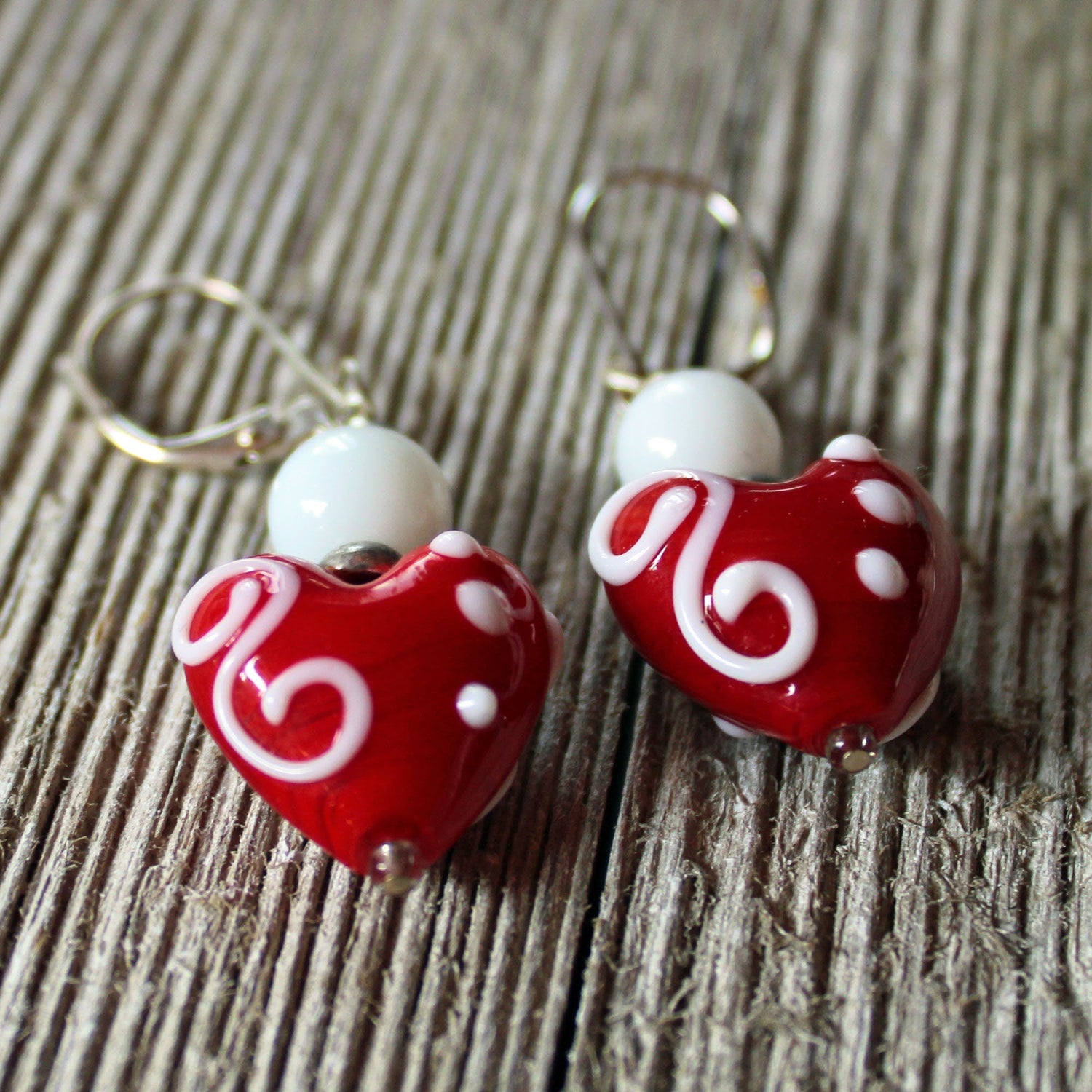 Heart Earrings - Tell her she has your heart with these stunning glass heart earrings. Featuring vibrant pink, red, and white lampwork design, these dangle earrings are a perfect statement piece for your love.