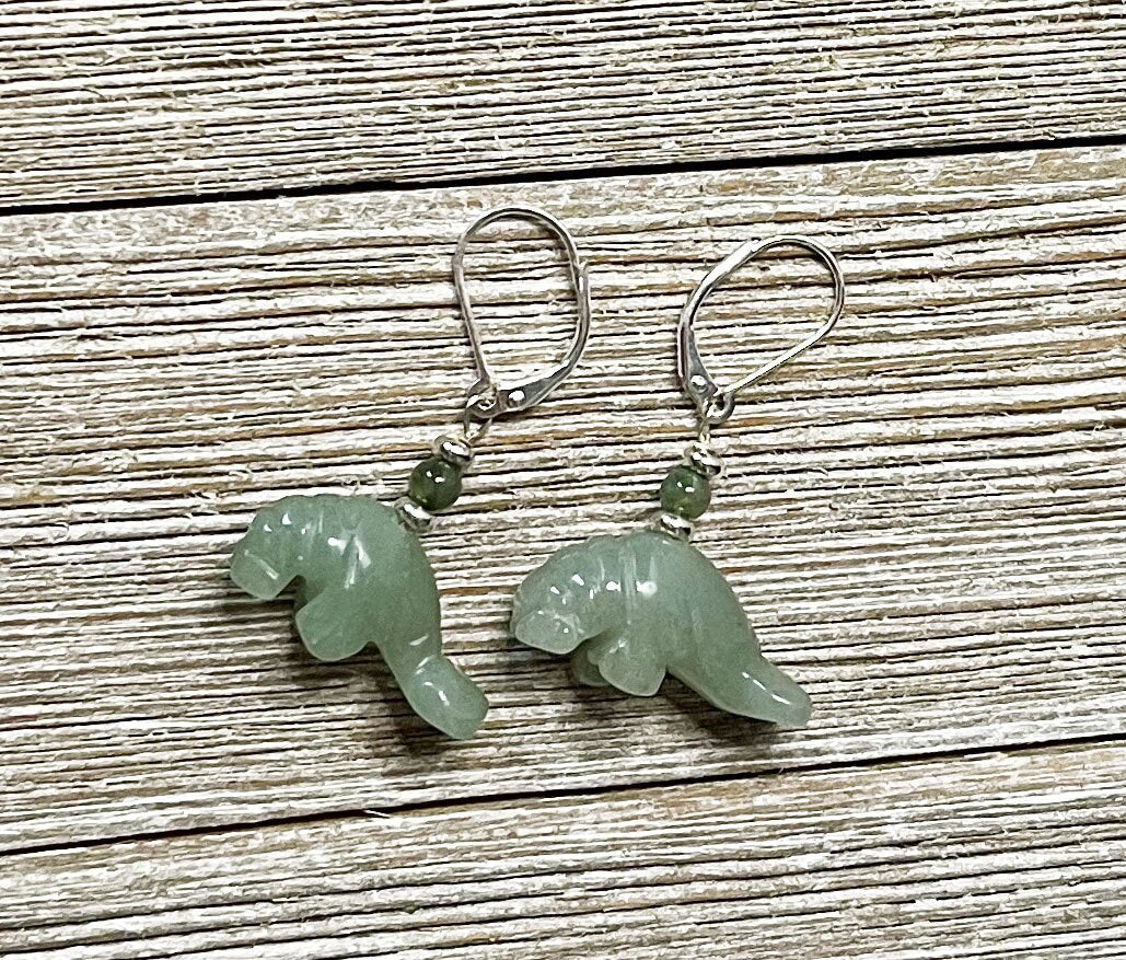 Green Aventurine Manatee Earrings: Handmade Sea Life Jewelry with green stone manatee charms and small green beads, displayed on light wood—ideal for sea life jewelry lovers.