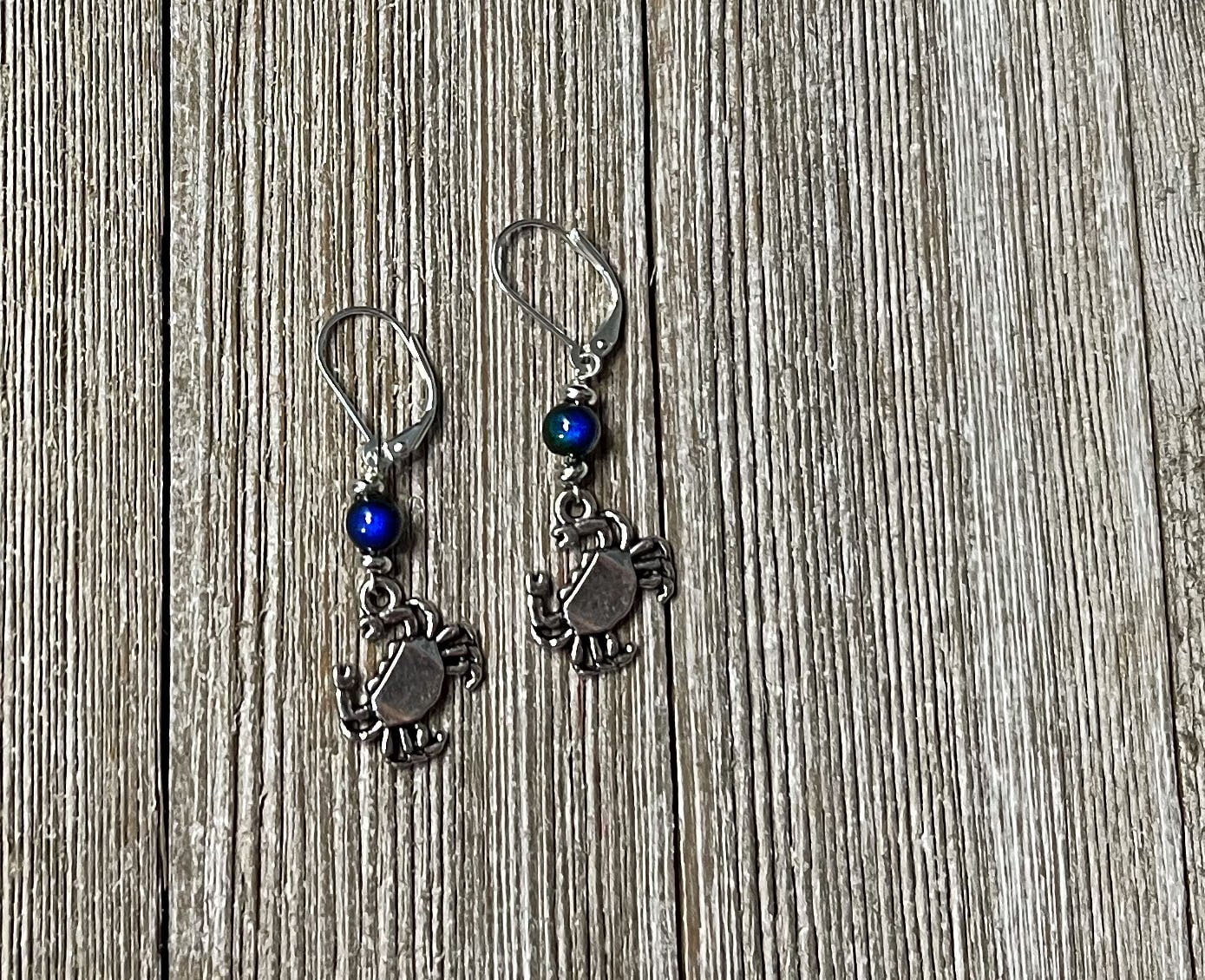 Color Changing Crab Dangle Earrings worn by a model, illustrating their cute and playful style for ocean lovers.