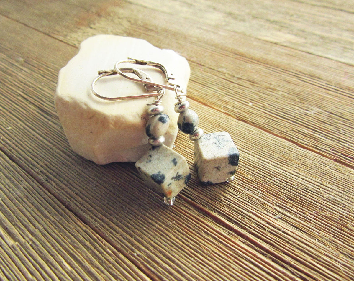 Close-up of Sacred Geometry Dalmatian Jasper Cube Earrings, highlighting the distinctive black spots of Dalmatian Jasper set in elegant sterling silver.