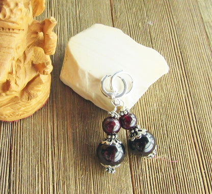 Close-up view of Sacred Geometry Garnet Earrings with detailed craftsmanship in sterling silver lever back earwires.