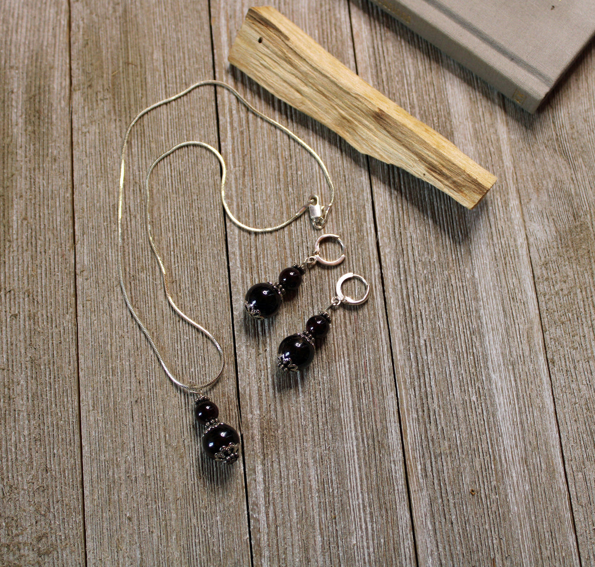 Close-up view of Sacred Geometry Garnet Earrings showcasing intricate geometric shapes and 925 sterling silver craftsmanship.