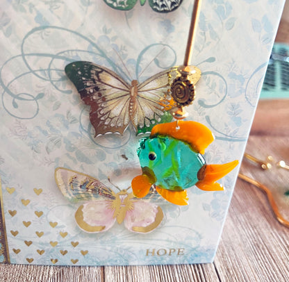 Close-up of the Glass Fish bookmark, showcasing the vibrant colors and whimsical design of this fun page holder for readers.