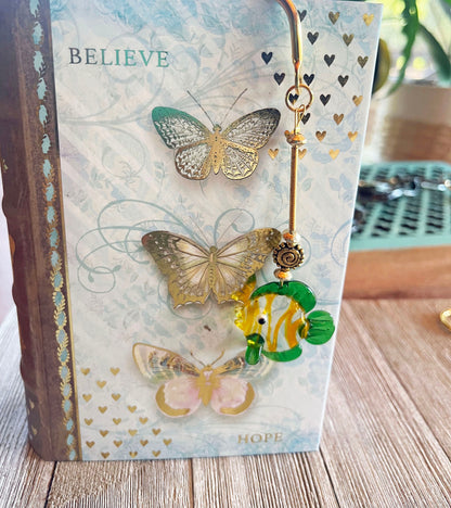 Fun Aquatic Gold Metal Bookmark with a dangling glass fish design, ideal gift for book lovers and librarians.