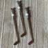 Set of three handcrafted golf ball stir sticks and spoon shaped like golf clubs, adorned with decorative beads, displayed on wood—a unique golfer barware gift for artisanal collections.