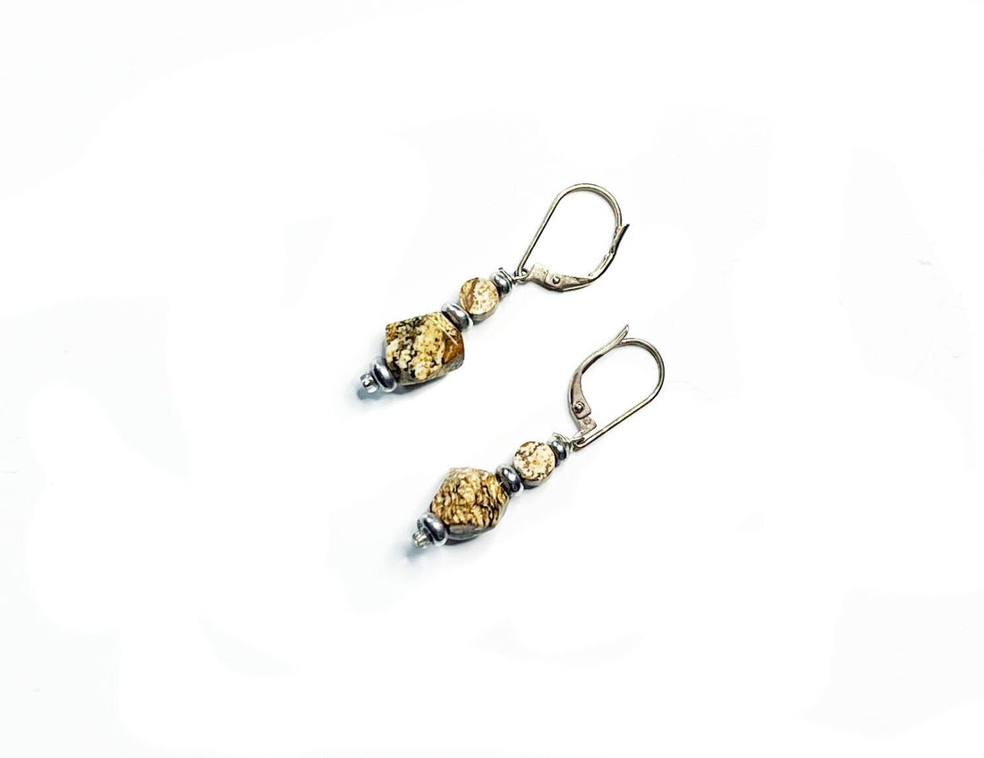 The Handcrafted Jasper Earrings feature sterling silver lever-back clasps and textured gold and silver beads for a geometric Zen look, beautifully presented on a white background.