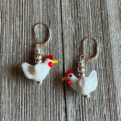 Close-up of the Hen Earrings Gift that is egg strodinary - highlighting unique white lamp work glass chicken design, ideal for chicken lovers and farm enthusiasts.