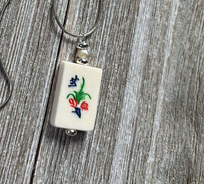 Elegant Mahjong Tile Necklace with flower motif, a unique jewelry piece for Mahjong enthusiasts.