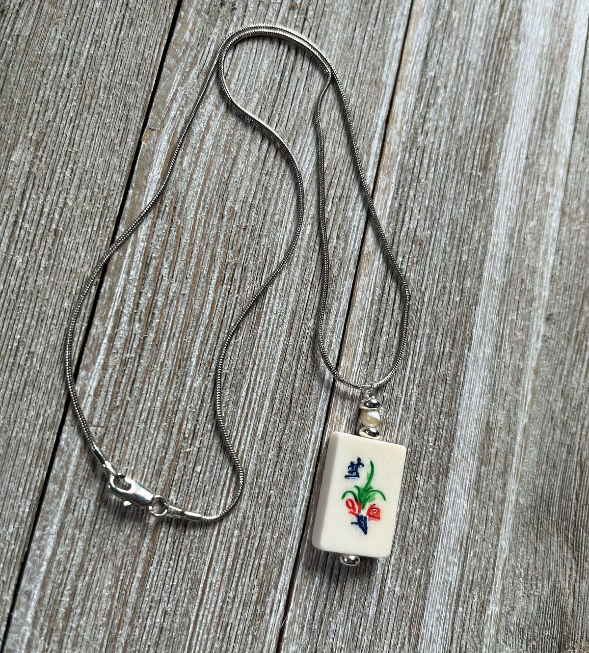 Set of Mahjong Tile Jewelry including earrings and necklace, flower bonus style for Mahjong enthusiasts.