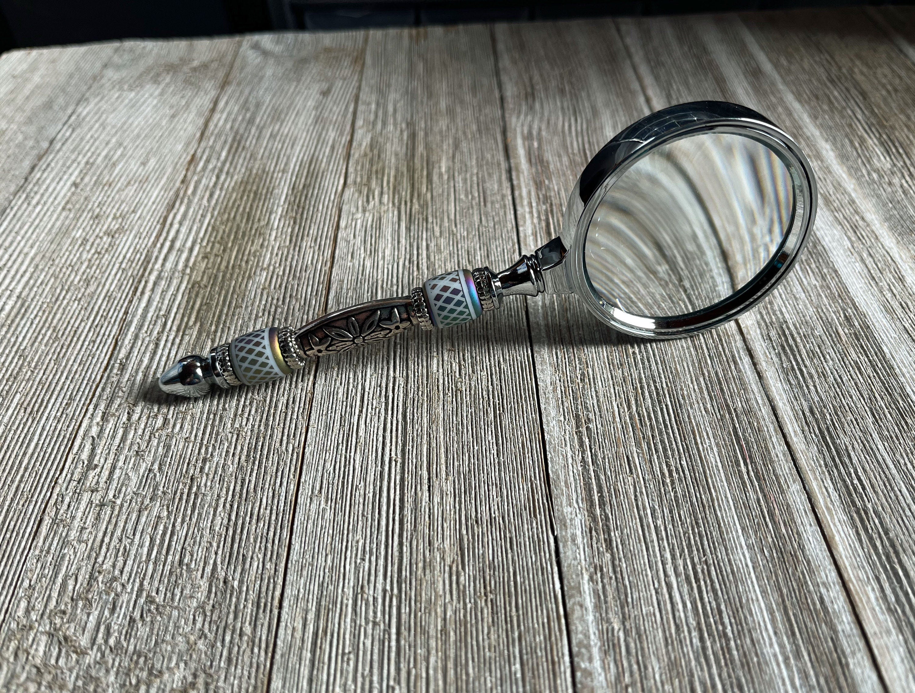 Stylish Eye Catching Gift - Shimmering Bead Handed Magnifier displayed on a table, highlighting its handcrafted quality and vintage design.