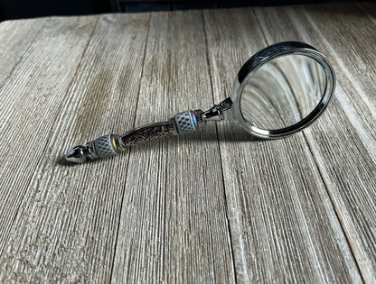 Stylish Eye Catching Gift - Shimmering Bead Handed Magnifier displayed on a table, highlighting its handcrafted quality and vintage design.