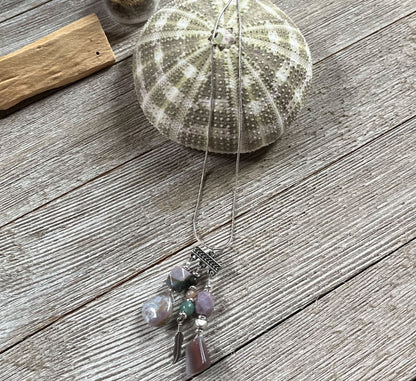Close up of Fancy Jasper Triple Charm Pendant Necklace, decorated with feather and colorful Jasper stones for spirituality.