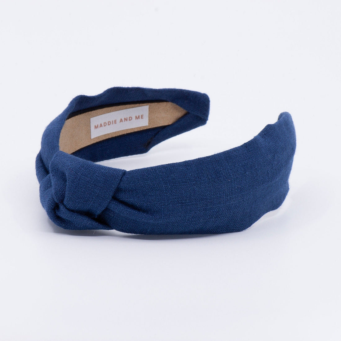 May include: A navy blue knotted headband with a brown label that reads &amp;quot;MADDIE AND ME&amp;quot;.