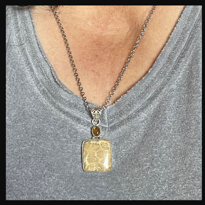 Close-up of Fossil Coral pendant in the Fossil Coral Jewelry Set with Topaz Topper, showcasing the intricate agate patterns in the coral stone.