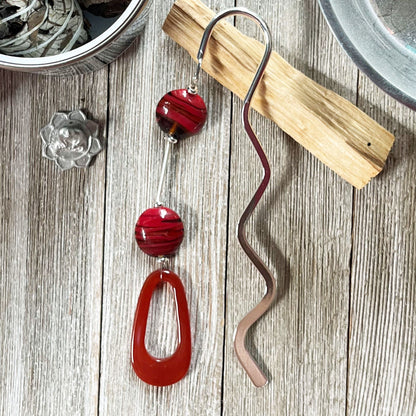 Art Glass and Carnelian Oval Hook Bookmark showcasing its elegant design, a perfect page holder for book lovers.