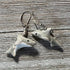 Grinning Shark Earrings: Hand-painted Ceramic Lever Back Jewelry in gray with white undersides, detailed fins, eyes, and teeth. Shown on a weathered wooden surface.