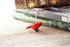 The Cardinal Bookmark features a porcelain red bird figurine on a silver metal bookmark, shown atop a green-covered poetry book and others on a wooden surface.