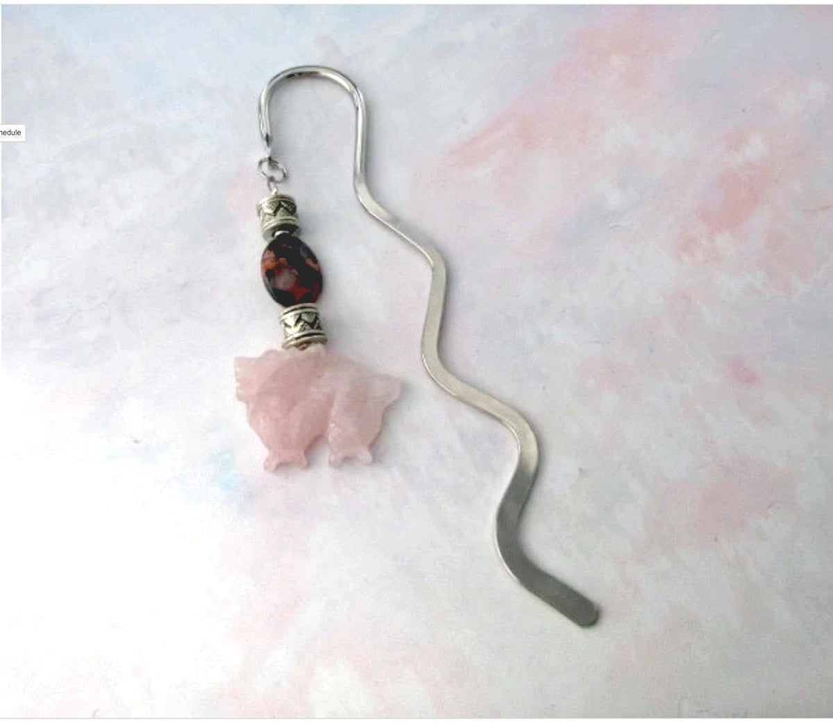A Dragon Bookmark with a rose quartz carved dragon, perfect for fantasy and mystery readers, is shown as a bullet journal page marker on a light pastel background.